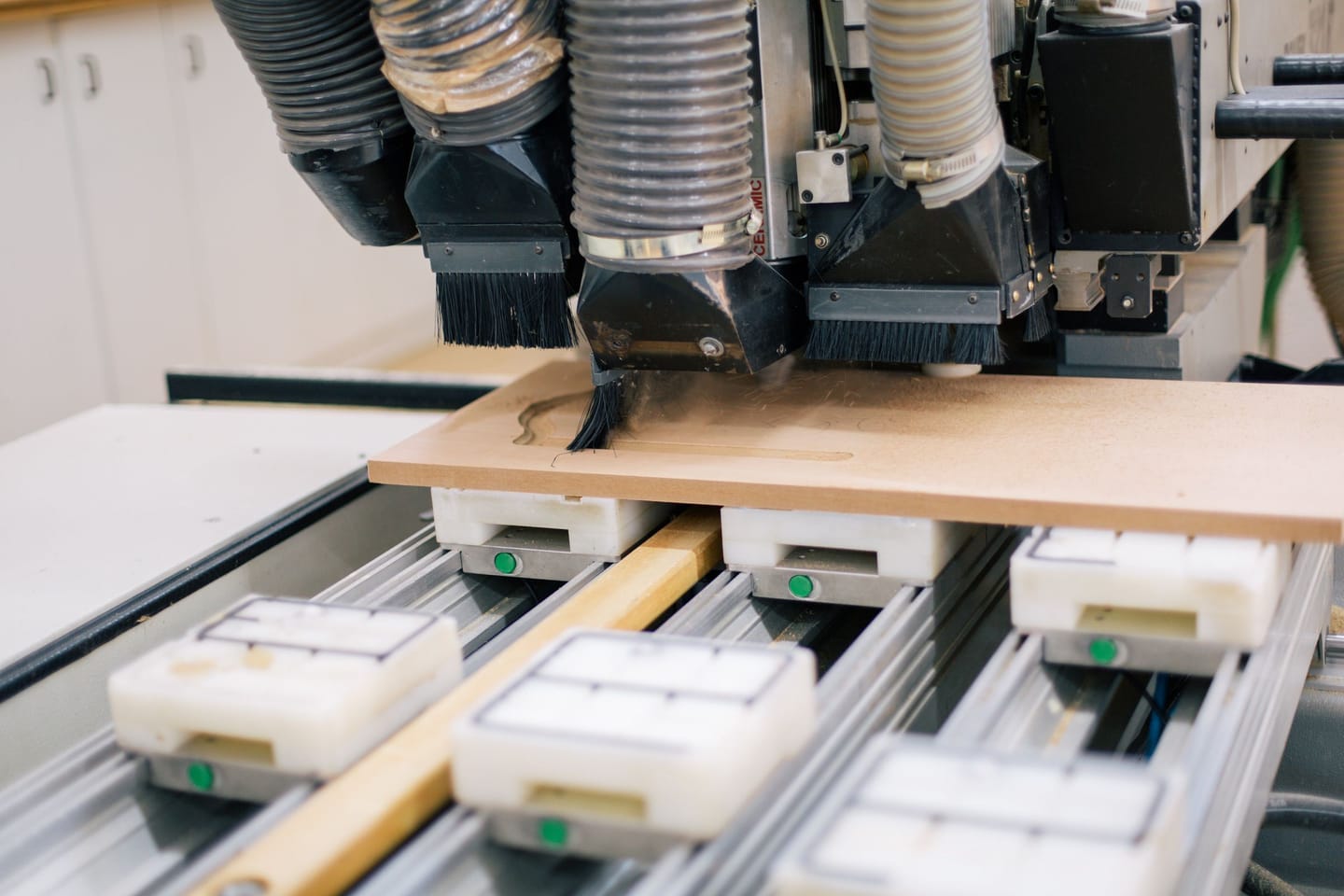 CNC nesting table cutting a furniture panel